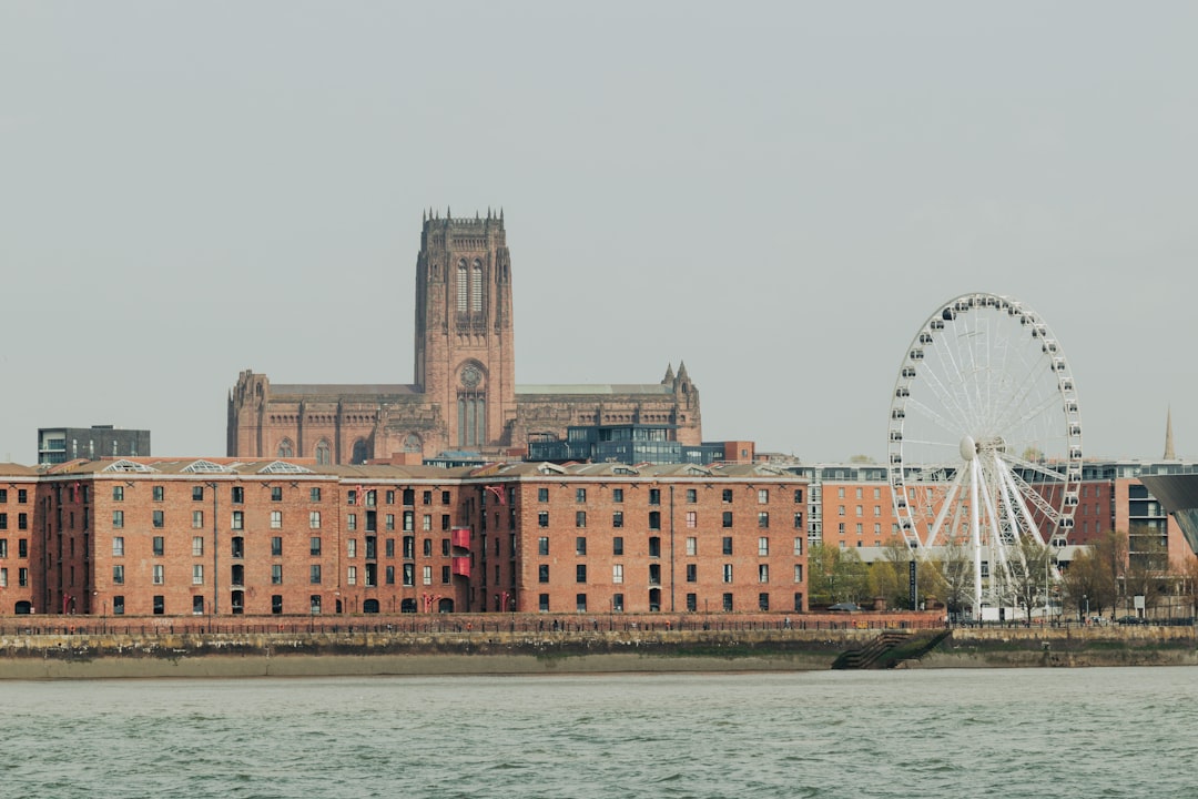 Historic brick buildings and ferris wheel by the water