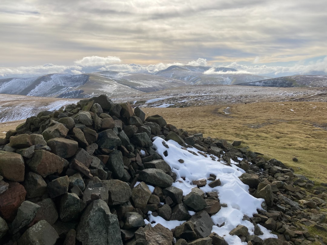 a pile of rocks sitting on top of a snow covered hillside